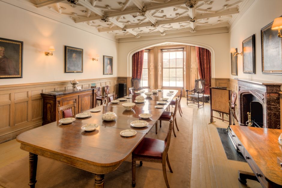 Wood-panelled meeting room with a long table and window light
